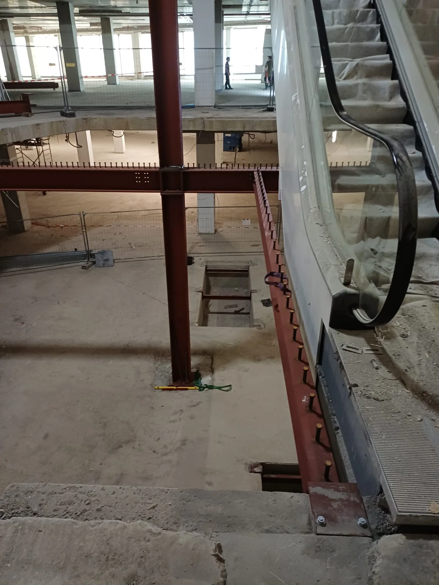 Rohbaugeschoss mit Stahlträgern und eingesetzter Rolltreppe